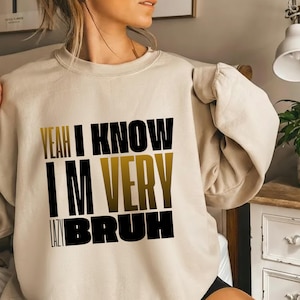 May include: A white ceramic mug with a black handle and the text "But First, Coffee" in a black, handwritten-style font. The mug is on a white surface.