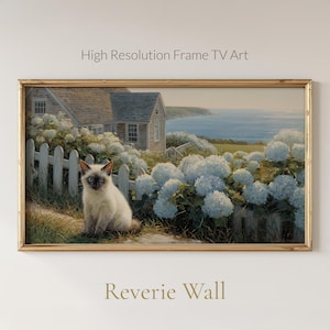 May include: A framed print featuring a coastal scene with a house, white picket fence, and a Siamese cat. The artwork is surrounded by white hydrangeas and overlooks the ocean. The text "High Resolution Frame TV Art" and "Reverie Wall" are visible.