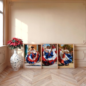 May include: Three framed wall art prints depicting dancers in voluminous white, red, and blue ruffled skirts, displayed alongside a tall, white, decorative ceramic vase filled with red poinsettia flowers on a light-colored wooden floor.