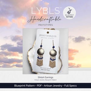 May include: A pair of Shiloh earrings on a white display card labeled Jenny Marquis Artisan Jewelry. The earrings feature a hammered gold disc, a single blue lapis lazuli bead, and a gold chain fringe with small blue lapis lazuli bead accents.