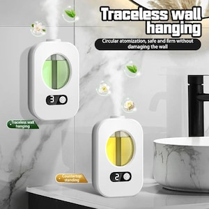 May include: Two white wall-mounted air fresheners with a digital display, one showing "3" and the other "2". The fresheners have a clear window showing the liquid inside. The text reads "Traceless wall hanging" and "Countertop standing".