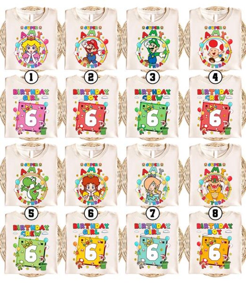 May include: A collection of cream-colored t-shirts featuring various cartoon characters and birthday-themed designs. Each shirt has a different character, such as Mario, Luigi, or Princess Peach, with the text "Super Amy" and a number 6. Some shirts say "Birthday Girl," "Birthday Boy," or "Birthday Crew."