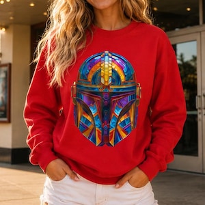 Colorful sci fi helmet sweatshirt in red with geometric futuristic mandolorian style armor artwork on a unisex crewneck.