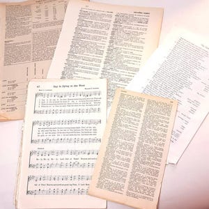 May include: A collection of vintage paper pages with text and music. The pages are yellowed with age and have a worn, antique look. The music sheet features the song "Day is Dying in the West".