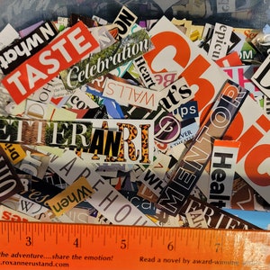 May include: A close-up of a bowl filled with colorful magazine clippings. The clippings are words and phrases, including "Taste", "Better", "Celebration", "Health", "New", and "Dog".