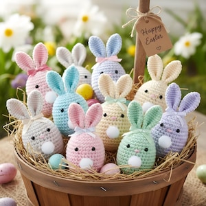 May include: A basket filled with colorful, crocheted Easter bunnies in pastel shades of pink, blue, green, and yellow. Each bunny has floppy ears, a small bow, and a fluffy white tail. A tag that says "Happy Easter" hangs from a wooden stick.