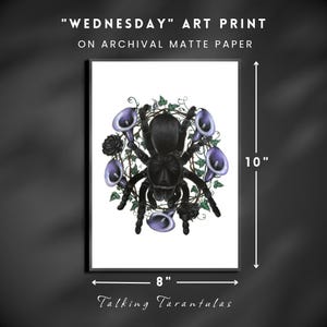 May include: A framed art print on archival matte paper. The artwork features a black tarantula surrounded by purple calla lilies and black roses, with green vines. The print is 10 inches tall and 8 inches wide. The text "WEDNESDAY" ART PRINT and "Talking Tarantulas" are visible.