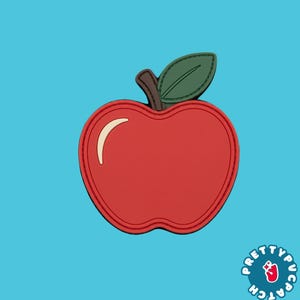 May include: A red apple-shaped patch with a brown stem and a dark green leaf. The apple features a curved cream-colored highlight on the left side and a stitched border detail. The text Pretty Patch is visible in the bottom right corner.