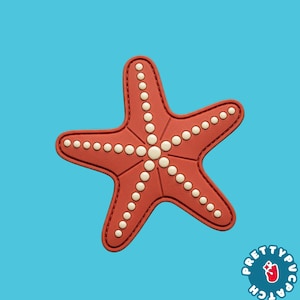 May include: A five-pointed starfish patch in a matte red finish with a series of raised, cream-colored circular dots lining each arm and the center. The patch features stitched edges and a logo in the bottom right corner reading Pretty Patch.