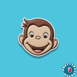 May include: A smiling monkey face with brown fur, tan skin, and a pink tongue. The monkey has large, expressive eyes and is outlined in white. The background is a solid light blue. The logo "PRETTYPUCA PATCH" is in the bottom right corner.