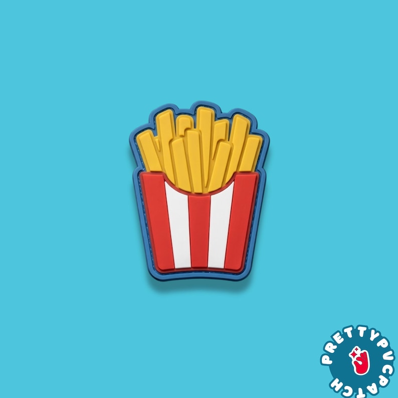 May include: A colorful patch featuring a cartoon depiction of a container of french fries. The fries are yellow, and the container is red with white stripes. The patch has a blue border and is set against a turquoise background.