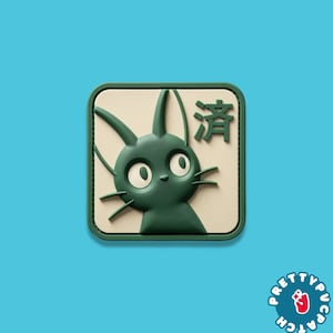 May include: A square patch with a green cartoon cat design on a cream background, framed by a green border. The patch features the Japanese character "済" and the text "PRETTYPUPPATCH" in a circular logo.