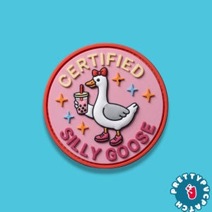 May include: A round, pink patch with a cartoon goose holding a bubble tea. The patch reads "CERTIFIED SILLY GOOSE" in a circular design. The goose wears a red bow and shoes. Orange and blue stars surround the goose.