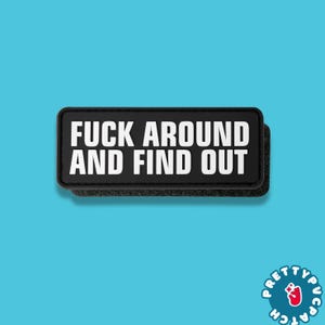 May include: A black rectangular patch with the text "FUCK AROUND AND FIND OUT" in white, bold letters. The patch has a hook and loop backing for attachment. The background is a solid light blue.