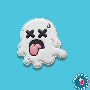 May include: A white ghost-shaped patch with black X-shaped eyes, a black open mouth, and a pink tongue sticking out. A small black curved mark is above the right eye. The text PRETTY PATCH is visible in a circular logo in the bottom right corner.