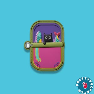 May include: A colorful patch featuring a black cat peeking out of a sardine can. The can is pink with a purple interior, green trim, and two fish. The patch has the text "PRETTYPUC PATCH" in a circle.