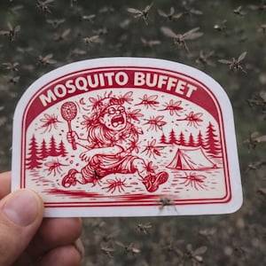 May include: A red and white sticker with the words "MOSQUITO BUFFET" and a cartoon illustration of a person running from mosquitoes. The person is holding a tennis racket and is near a tent and trees. The background is filled with flying mosquitoes.