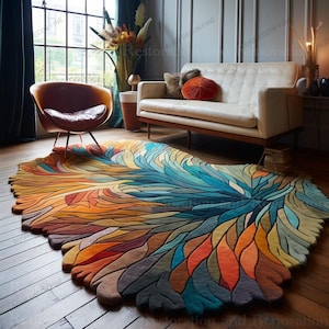 May include: A large, colourful area rug with an abstract design resembling a stylized feather or floral pattern. The rug features a vibrant palette of blues, oranges, yellows, and greens, creating a focal point in a living room setting.