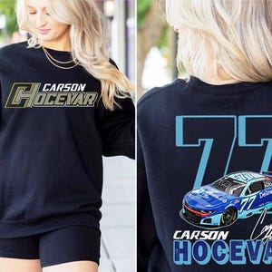 May include: A black crewneck sweatshirt featuring the text Carson Hocevar in white and yellow on the front. The back displays a large light blue number 77, a blue race car graphic, and the text Carson Hocevar with a signature in white.