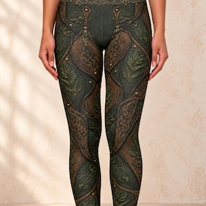May include: High-waisted leggings featuring a dark green and brown color palette with a printed design of overlapping leather-like panels, intricate Celtic knotwork, embossed leaf patterns, and small metallic stud accents throughout the fabric.