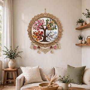 May include: A circular wall hanging featuring a four-season tree design crafted with crochet and embroidery techniques. The tree is divided into four sections representing spring, summer, autumn, and winter, surrounded by a decorative macrame border.