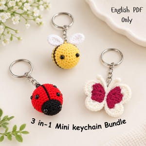 May include: Three crochet keychains featuring a yellow and black bee, a red and black ladybug, and a white and pink butterfly. The text reads English PDF Only and 3-in-1 Mini keychain Bundle. Each keychain has a silver metal ring and chain.
