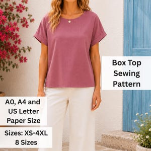 May include: A mauve box top sewing pattern featuring short sleeves with cuffs and a round neckline. The text on the image indicates A0, A4, and US Letter paper sizes, with 8 sizes available ranging from XS to 4XL for this garment design.