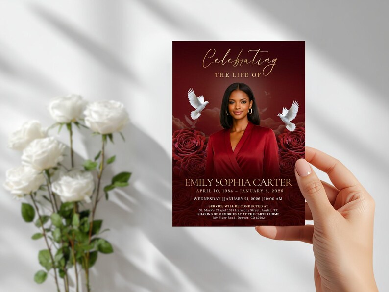 May include: A funeral program card featuring a deep red background with dark roses, two white doves, and a portrait of a person in a red top. The text reads Celebrating the life of Emily Sophia Carter, April 10, 1984 &ndash; January 6, 2026.
