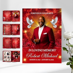 May include: A memorial poster with the text "FOREVER IN OUR HEARTS" and "IN LOVING MEMORY Robert Michael AUGUST 27, 1962 - JANUARY 10, 2026". The poster features a man in a red suit, doves, and red roses. Also shown are memorial booklets.