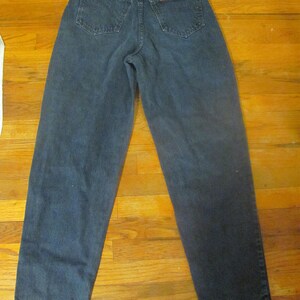 May include: A pair of dark blue denim jeans with a high waist and a straight leg.