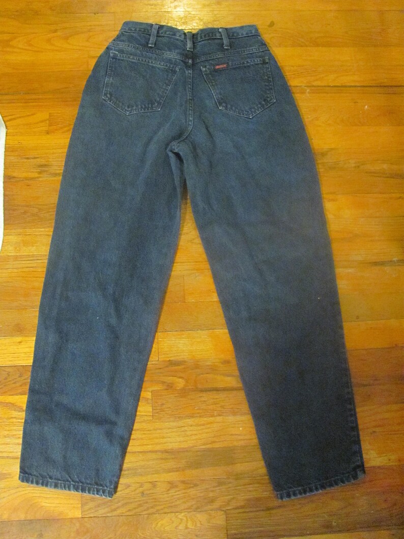 May include: A pair of dark blue denim jeans with a high waist and a straight leg.