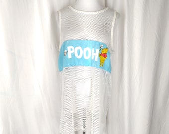 May include: White mesh sleeveless shirt with a blue and white patch featuring Winnie the Pooh and the word "POOH" in white letters.