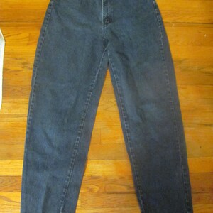 May include: A pair of dark blue denim jeans with a high waist and a straight leg.