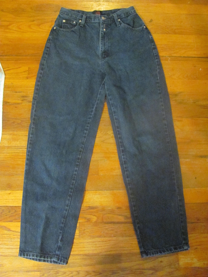 May include: A pair of dark blue denim jeans with a high waist and a straight leg.