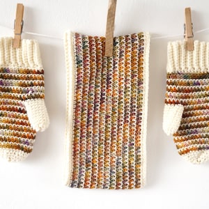 May include: A set of crocheted fingerless gloves and a matching scarf in a multi-colored yarn with shades of brown, orange, and purple. The yarn has a speckled effect.