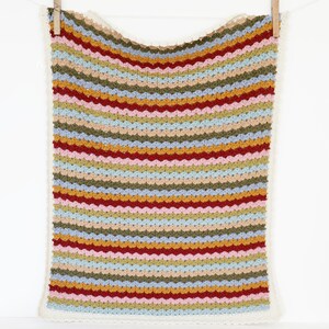 May include: A multi-colored striped crochet baby blanket with a white crocheted border. The blanket features stripes of red, pink, blue, green, yellow, and brown.