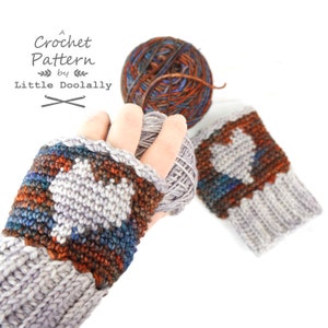 May include: A crochet pattern for fingerless gloves with a heart design. The gloves are made with a grey yarn with brown, blue, and teal accents. The yarn is shown in the background.