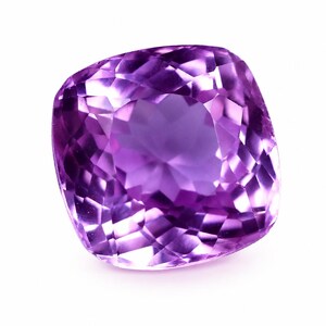 May include: A cushion-cut amethyst gemstone with a vibrant purple hue and a faceted surface. The stone displays a high level of clarity and brilliance, with numerous triangular and quadrilateral facets reflecting light across its polished surface.