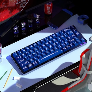 May include: A mechanical keyboard with a dark blue frame and matching blue keycaps featuring white space-themed icons and lettering. The spacebar displays the text "INTERSTELLAR JOURNEY" in white, and the keys include various celestial symbols.