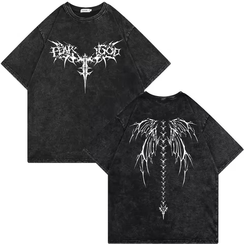 May include: A black acid-wash t-shirt featuring a white graphic print. The front displays a stylized cross design with the text "FEAR GOD" in a jagged font. The back features a large, intricate white graphic of symmetrical wings and a spine.