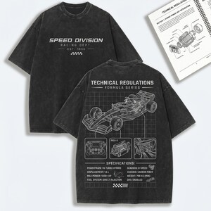 May include: A charcoal grey acid-wash t-shirt featuring a front graphic with the text SPEED DIVISION RACING DEPT. EST. 1996. The back displays a technical diagram of a race car, the text TECHNICAL REGULATIONS FORMULA SERIES, and specifications.
