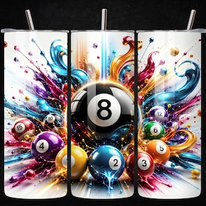 May include: A white tumbler with a colorful design featuring a black 8-ball and other billiard balls. The design includes splashes of blue, purple, yellow, and orange, with a stainless steel straw.