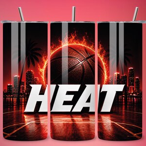 May include: A stainless steel tumbler with a basketball design surrounded by flames, and the word "HEAT" in white. The design includes a cityscape silhouette and palm trees, set against a dark background.