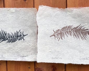 gold feather and black feather pair of linoprints on handmade paper