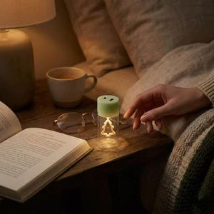 May include: A set of three ceramic nesting bowls in shades of blue, green, and white. The bowls feature a speckled glaze and a simple, modern design. The largest bowl is approximately 6 inches in diameter.