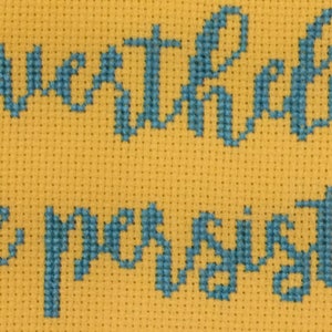 May include: Cross-stitch embroidery on yellow fabric with the text "Never underestimate the power of a sister".