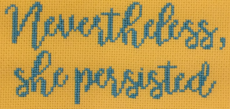 May include: Cross-stitch embroidery on yellow fabric with the text "Never underestimate the power of a sister".