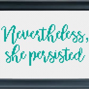 May include: Cross-stitch pattern with teal colored embroidery floss on white fabric. The pattern reads "Nevertheless, she persisted."