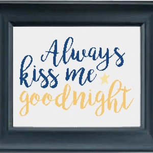 May include: A framed cross-stitch design with the text "Always kiss me goodnight" in blue and yellow lettering with a small yellow star.