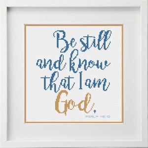 May include: A white cross-stitch pattern with blue and gold text. The text reads "Be still and know that I am God." with the scripture reference "PSALM 46:10" below.